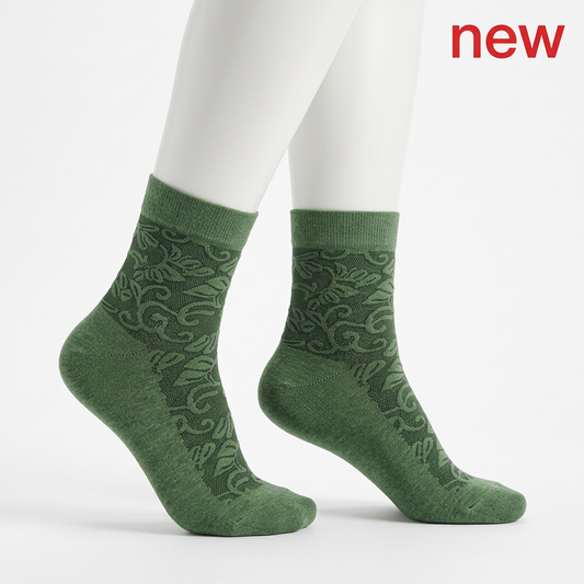 Green spiral and floral socks on feminine-proportioned white mannequin legs